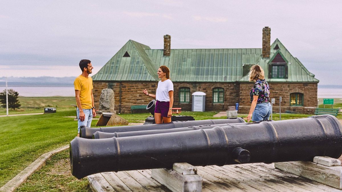 Visitors exploring historic cannons at Fort Beauséjour National Historic Site in Aulac, New Brunswick.